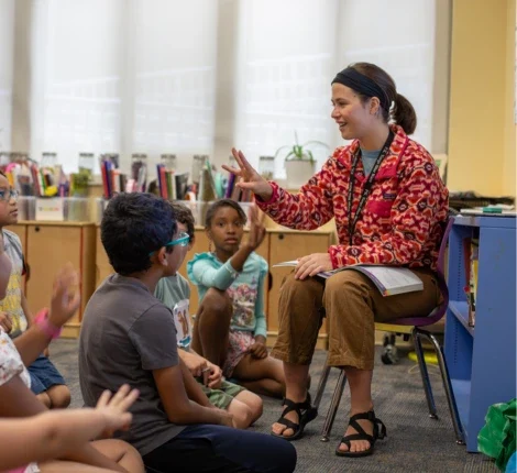 A teacher speaking with her class of of students